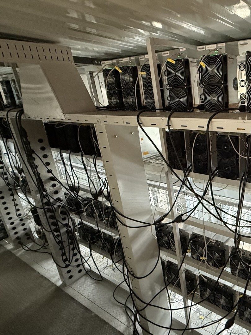 Rack of ASIC mining units with cable management.